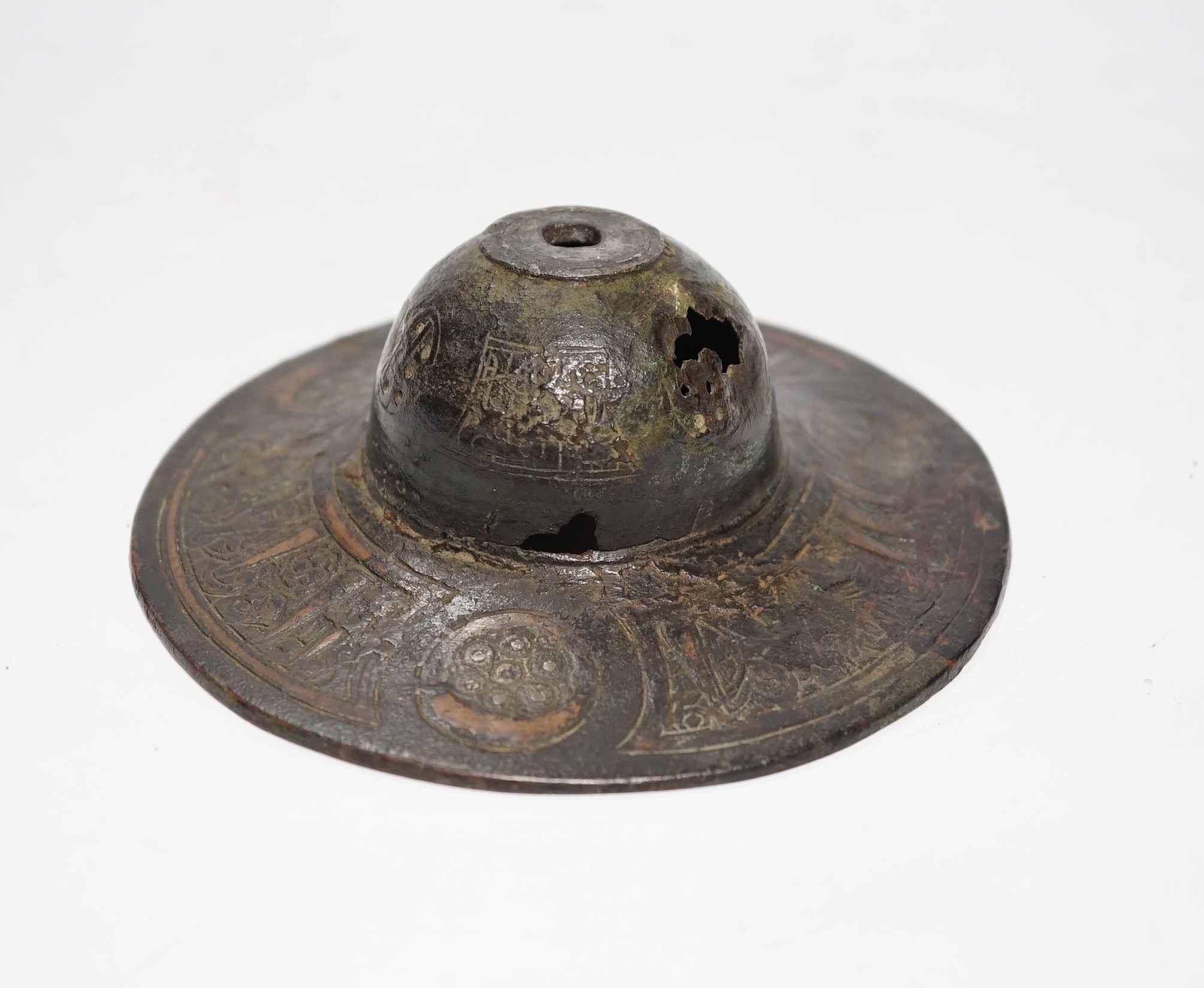An early Islamic bronze and copper inlaid shield or door boss, probably 12th/13th century, 14.5cm
